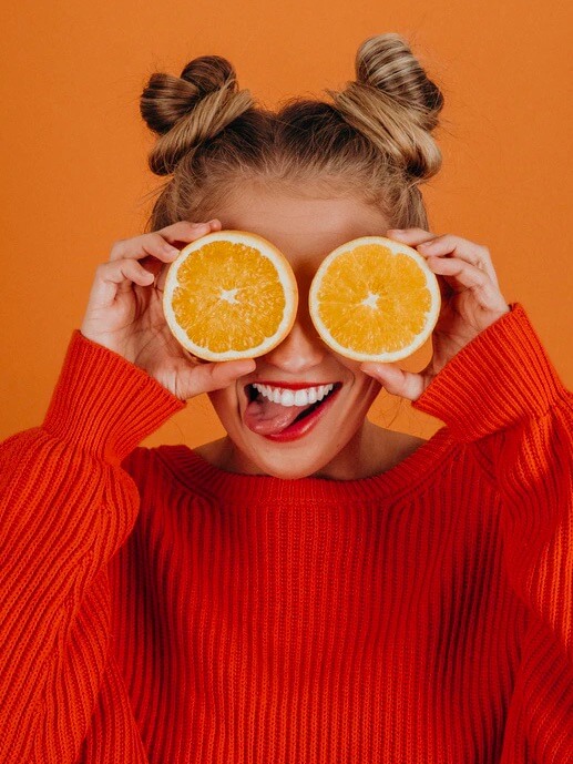 Babel Big Data Orange.  Funny young woman with half of two oranges put on her eyes