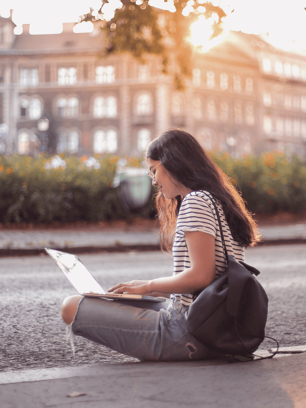 Girl on the street using a laptop